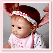 Ashton-Drake Galleries baby doll headband application tip: push the headband down until it's just right