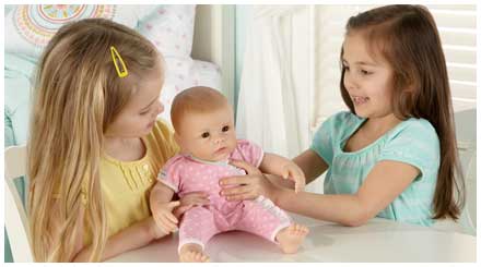 So Truly Mine doll photo gallery: two young girls holding a So Truly Mine baby doll dressed in pink